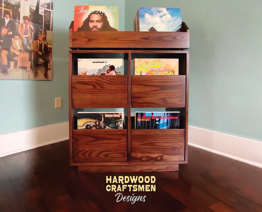 Dovetail 2 x 3 vinyl record storage features 4 pull out drawers below 2 flip bins. This LP cabinet is available in solid walnut, ash, red oak, maple, cherry and oak, all on a 3 inch 100% hardwood plinth base.