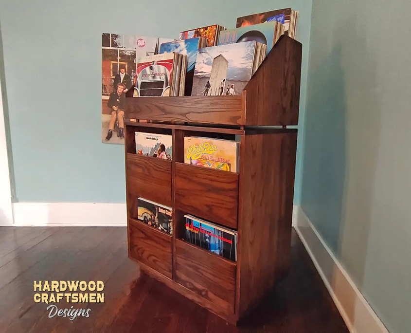 Dovetail 2 x 3 vinyl record storage with 4 pull out storage drawers and 6 flip bins. This LP cabinet is available in solid walnut, ash, red oak, maple, cherry and oak, all on a 3 inch 100% hardwood plinth base.