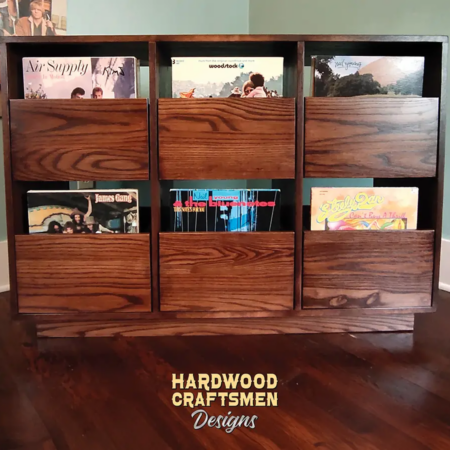 Dovetail 3 x 2 tv stand features 6 pull out vinyl storage drawers below a turntable and equipment shelf. This record player cabinet is available in solid walnut, ash, red oak, maple, cherry and oak, all on a 3 inch 100% hardwood plinth base.