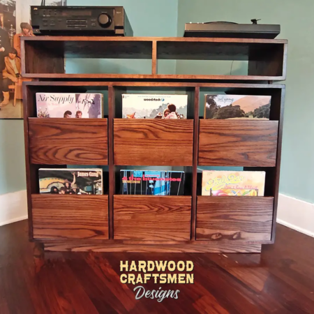 Dovetail 3 x 2.5 record storage cabinet features 6 LP drawers below an audio equipment and turntable shelves. This vinyl player stand is available in solid walnut, ash, red oak, maple, cherry and oak, all on a 3 inch 100% hardwood plinth base.