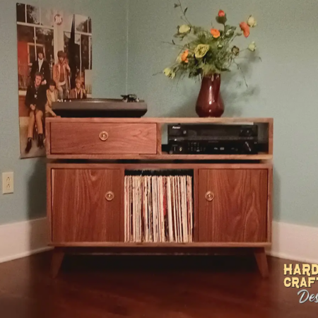 Solid walnut media console 2-door 3 x 1.5 layout with 3 vinyl bin compartments, available from 42 to 72 inches. This record player stand with dovetail drawers & credenza features an upper TV shelf above three divided compartments, all on tapered mid-century legs.