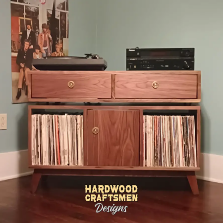 Media console with drawers in solid walnut 3 x 1.5 with 3 vinyl bin compartments, available from 42 to 72 inches. This record player stand features an upper TV shelf above three divided compartments, all on tapered mid-century legs.