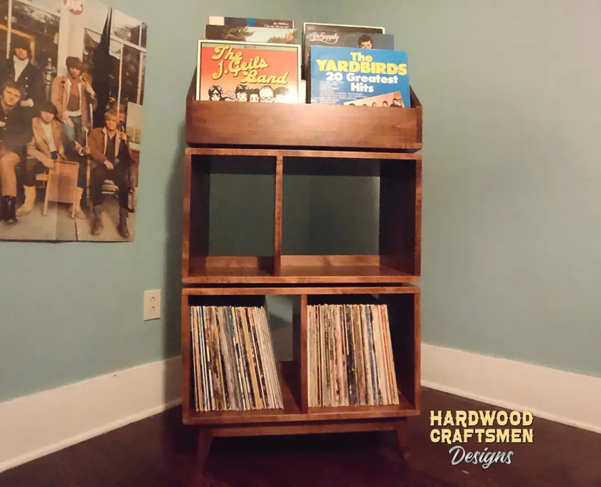 Record storage cabinet in solid maple features 4-to-8 storage compartments below 6-to-12 LP flip bins. This vinyl stand 5-tier is available from 28-to-56-inches, all on tapered mid-century legs.